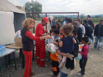 Mazedonische Helfer verteilen Wasser und Lebensmittel an die ankommenden Flüchtlinge. Foto: BR | Schaban Bajrami