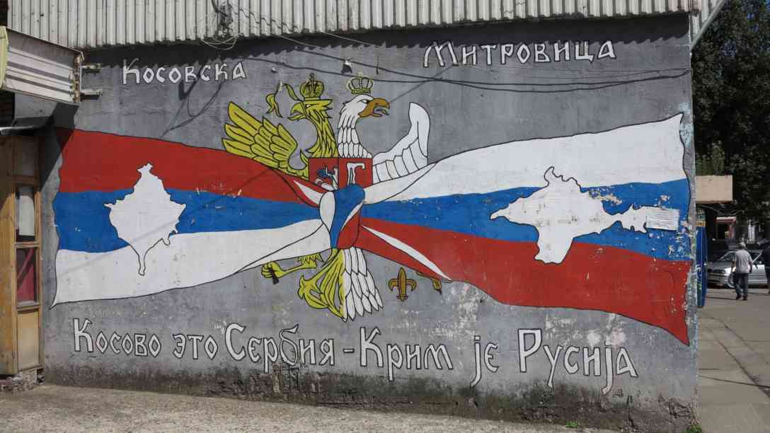 Ein provozierendes Graffiti in Mitrovica, das die Haltung radikaler Serben beschreibt. Links die serbische und rechts die russische Flagge, auf serbisch und russisch der Slogan 
