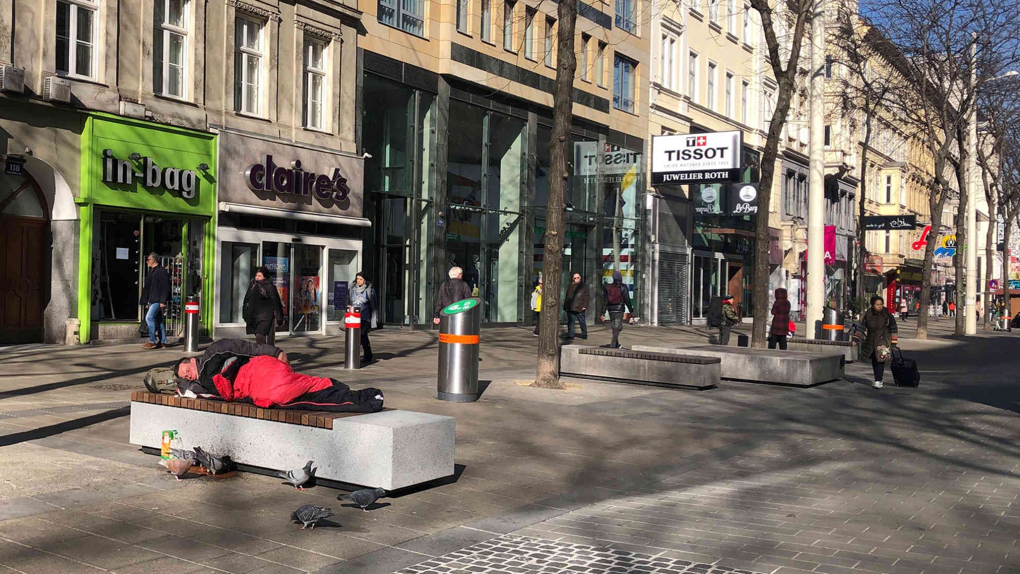 Ein Mann ohne Obdach liegt in der Mariahilfer Straße in Wien. In der ansonsten belebten Einkaufsstraße im Zentrum von Wien sind die meisten Geschäfte geschlossen. Foto: BR | Andrea Beer
